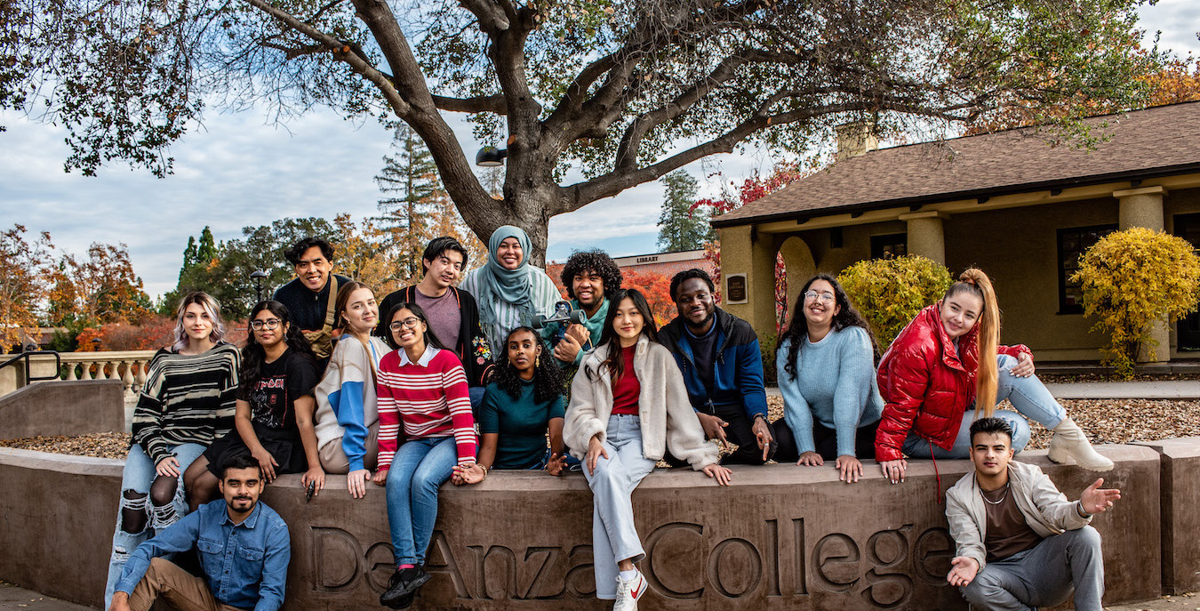 students seated on low concrete wall