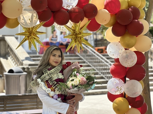 nursing student with bouquet and balloons