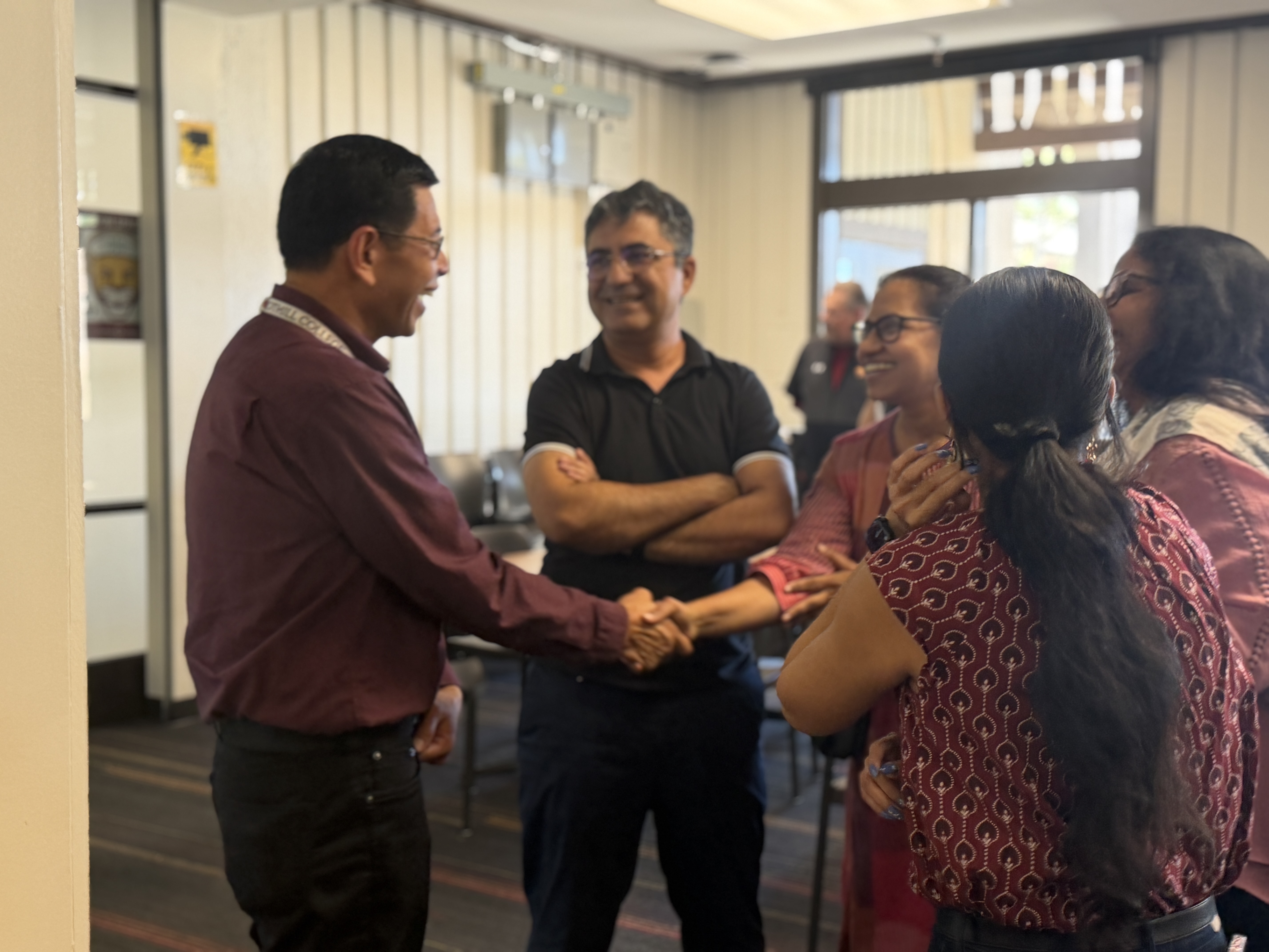 Dr. Christopher Dela Rosa greets members of the campus community