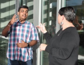 two students speaking in American Sign Language